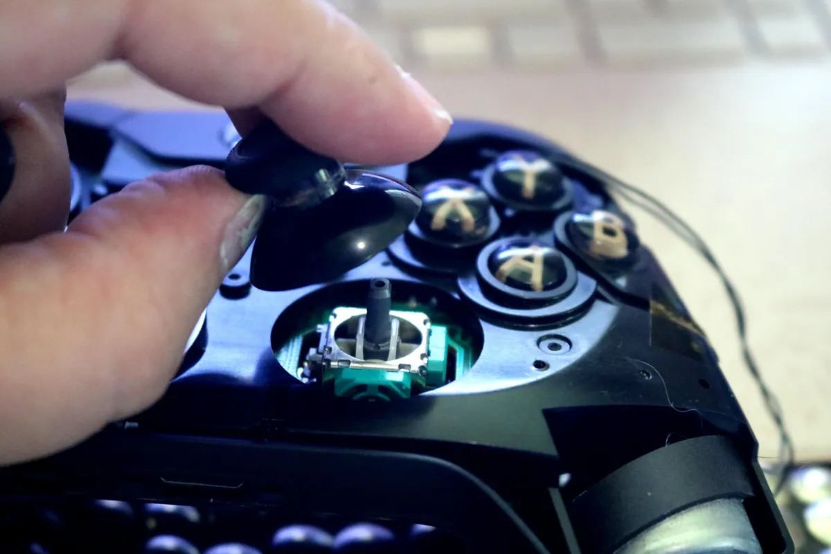 Replacing a joystick cap on an Xbox controller during repair